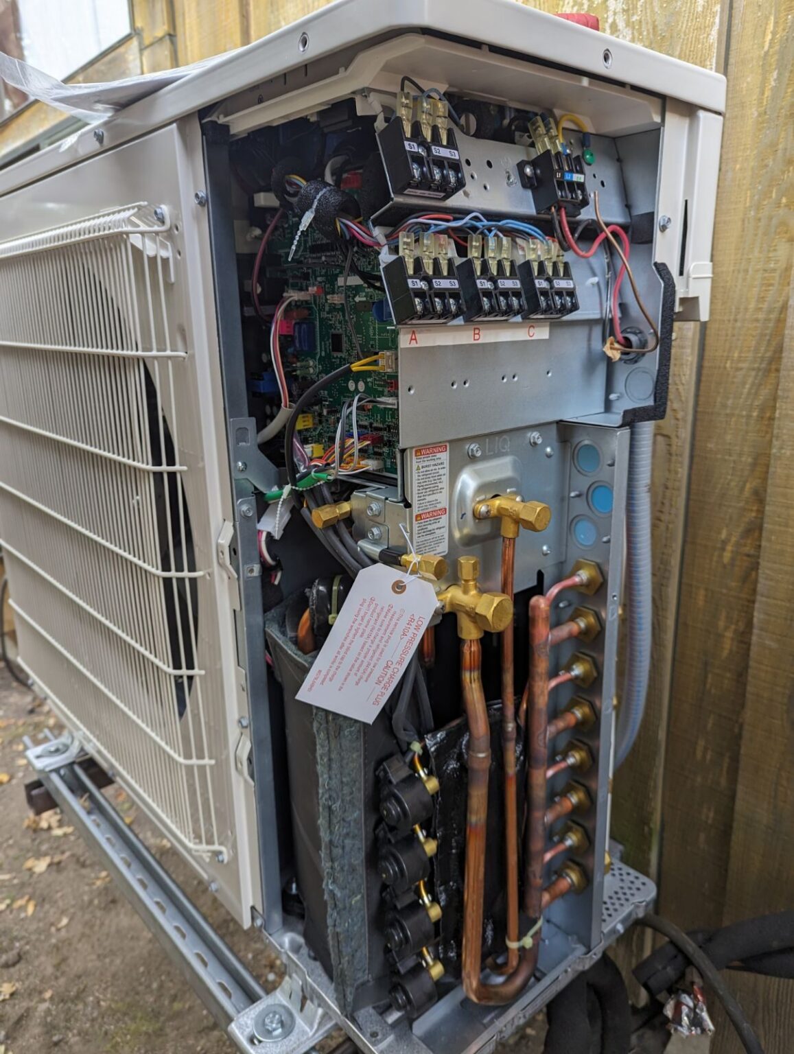 Open HVAC system cabinet showing internal components and wiring