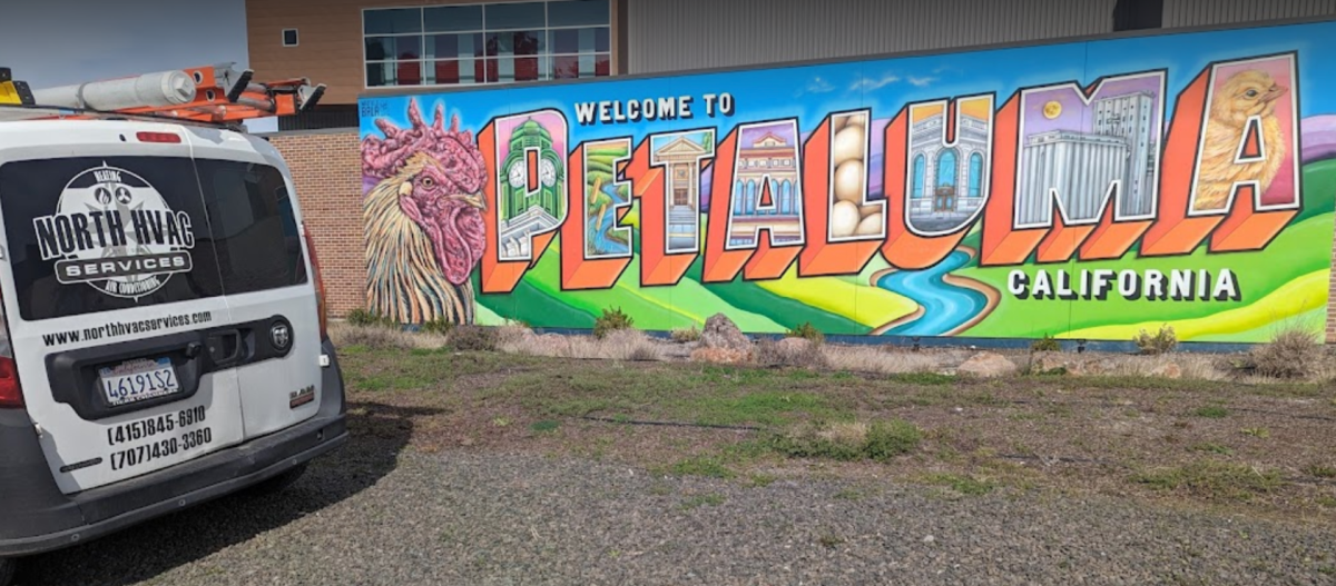 A van is parked in front of a mural of petaluma, california.