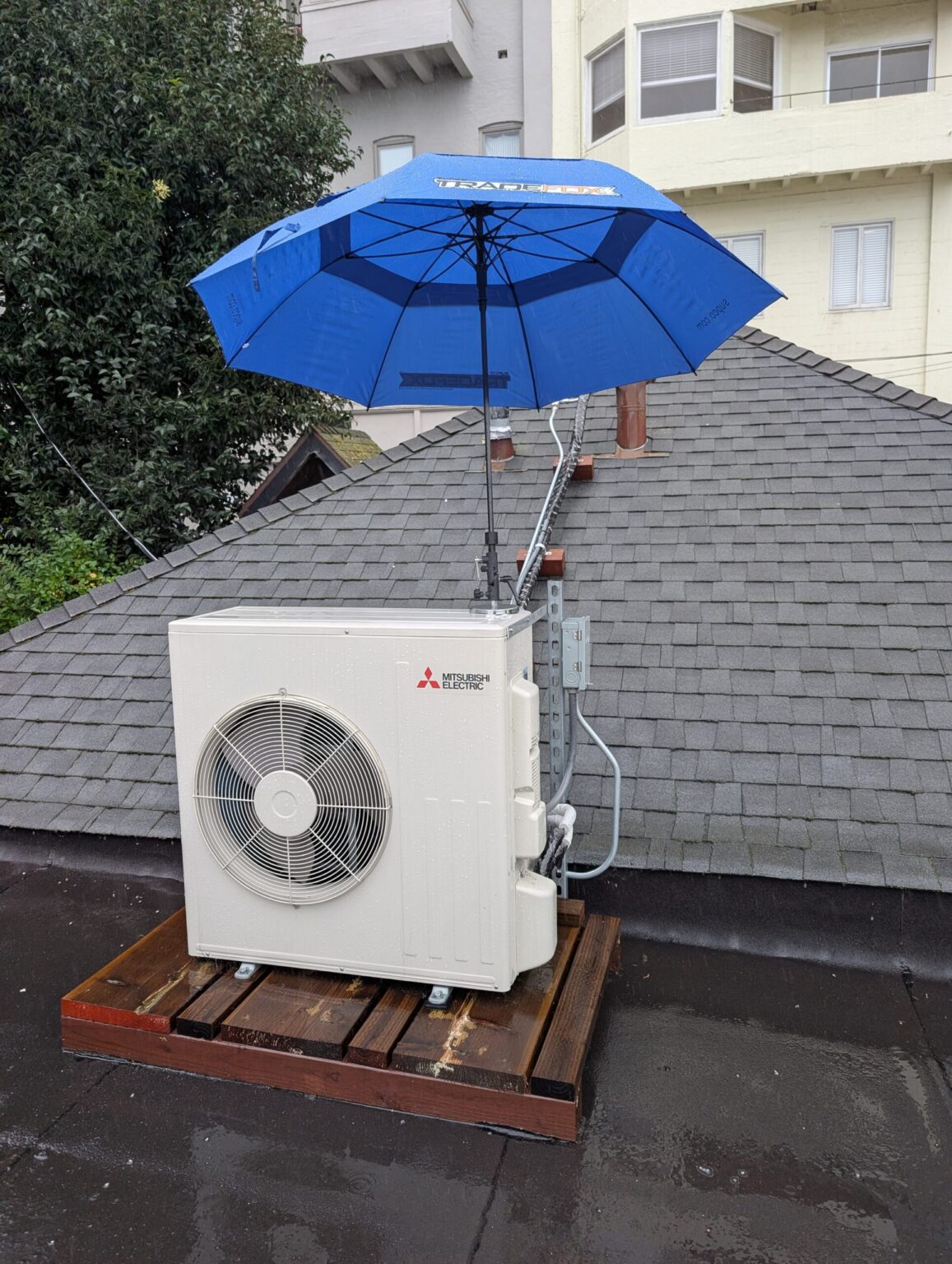 Outdoor mini-split condenser installed beside a rooftop patio